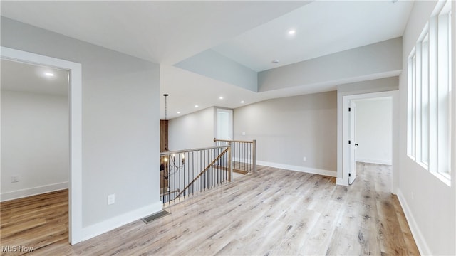 spare room with recessed lighting, baseboards, and wood finished floors