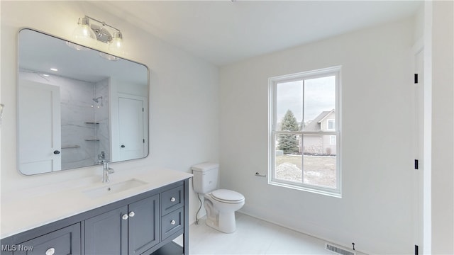 bathroom with visible vents, vanity, walk in shower, and toilet