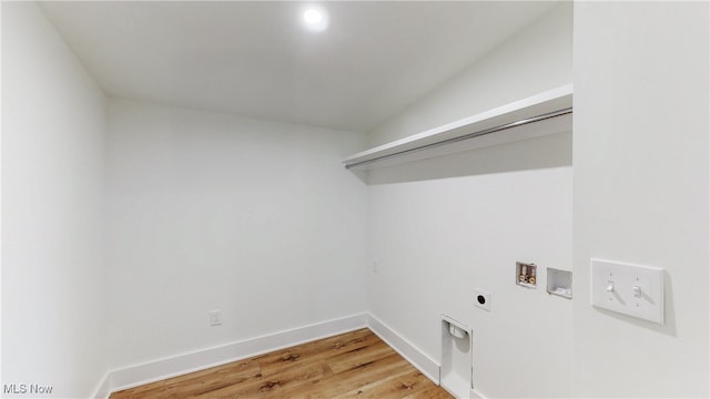 laundry area with light wood-style flooring, hookup for an electric dryer, laundry area, washer hookup, and baseboards