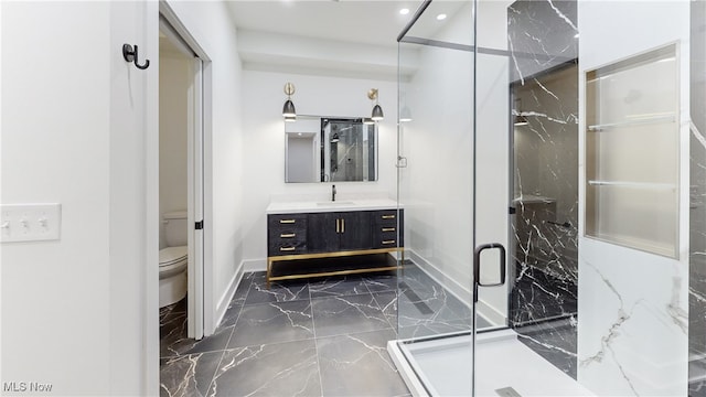 bathroom featuring marble finish floor, a marble finish shower, recessed lighting, toilet, and vanity