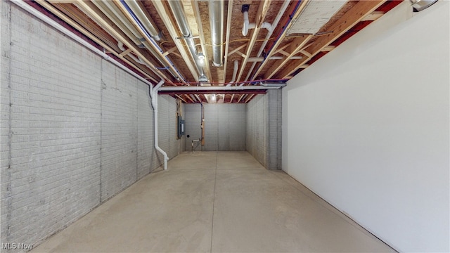 unfinished basement featuring brick wall