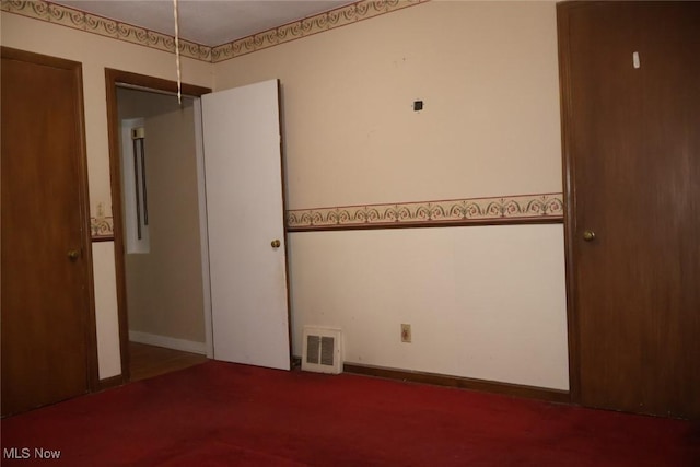 unfurnished bedroom featuring baseboards and visible vents