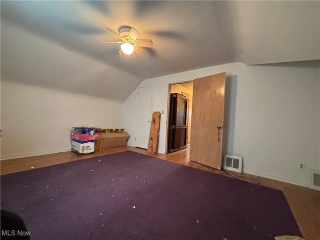 additional living space featuring lofted ceiling, visible vents, and baseboards