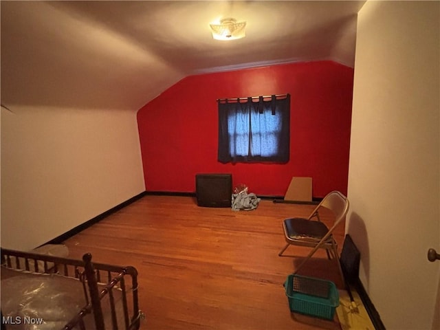 bonus room with vaulted ceiling, baseboards, and wood finished floors