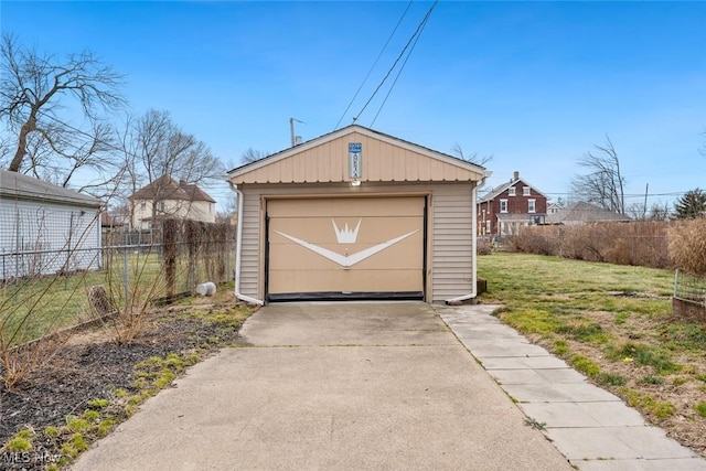 view of outbuilding featuring an outbuilding, driveway, and fence