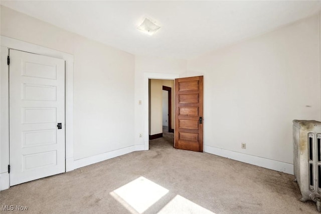 interior space featuring carpet flooring and baseboards