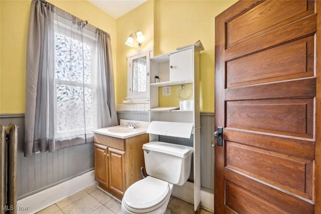 bathroom with vanity, toilet, and tile patterned floors