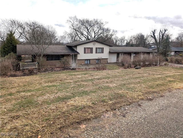 split level home featuring a front lawn