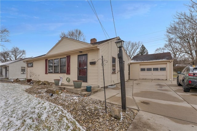 view of front of property with a garage, driveway, and a chimney