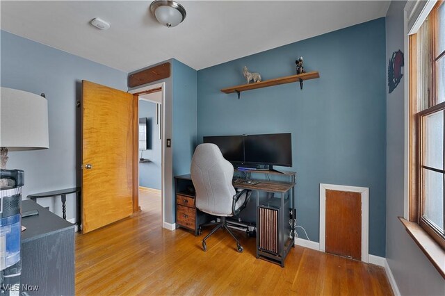 office space with wood finished floors and baseboards