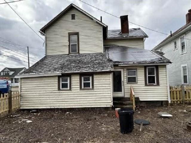 rear view of house with fence