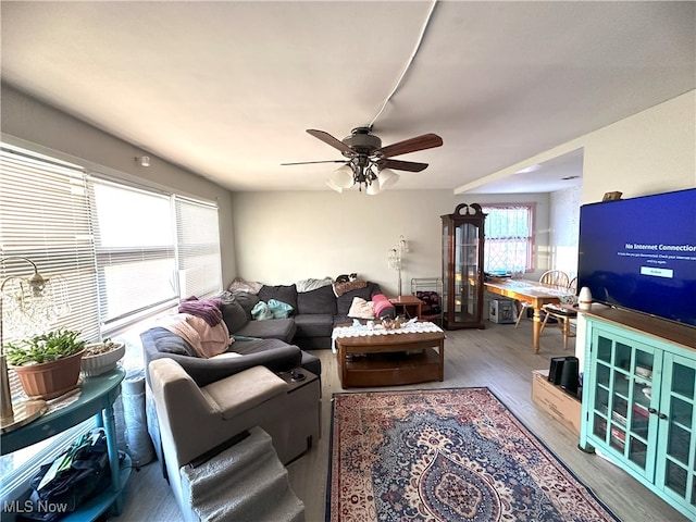 living room with ceiling fan and wood finished floors