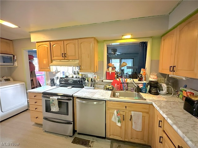 kitchen with light brown cabinets, stainless steel appliances, a sink, ventilation hood, and washer / clothes dryer