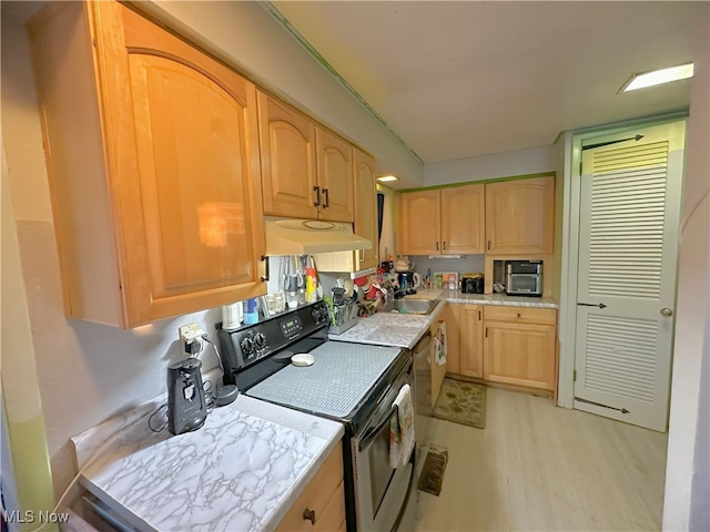 kitchen featuring under cabinet range hood, light wood-style flooring, electric stove, and light brown cabinetry