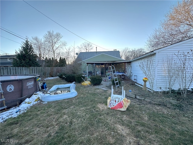 exterior space with a yard, fence, and a fenced in pool