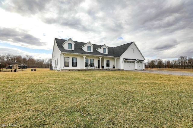 view of front of home featuring an attached garage, a porch, aphalt driveway, and a front yard