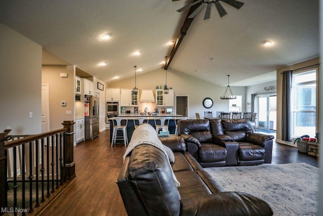 living room with dark wood-type flooring and vaulted ceiling with beams