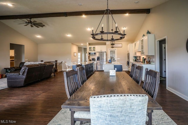 dining room with ceiling fan with notable chandelier, beam ceiling, dark wood-style floors, and baseboards