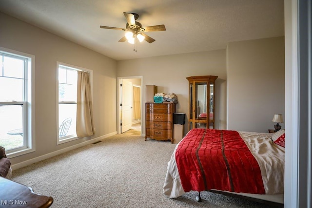 bedroom with carpet flooring, multiple windows, baseboards, and ceiling fan