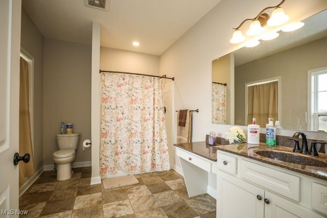 bathroom featuring vanity, baseboards, visible vents, curtained shower, and toilet