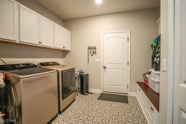 laundry area with washer and clothes dryer, light tile patterned floors, cabinet space, and baseboards