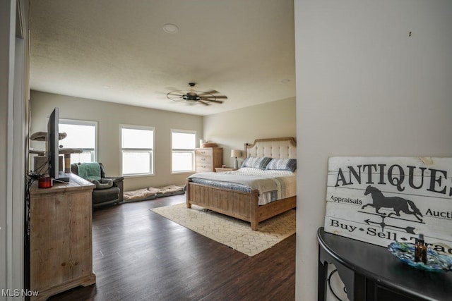 bedroom with ceiling fan and dark wood finished floors