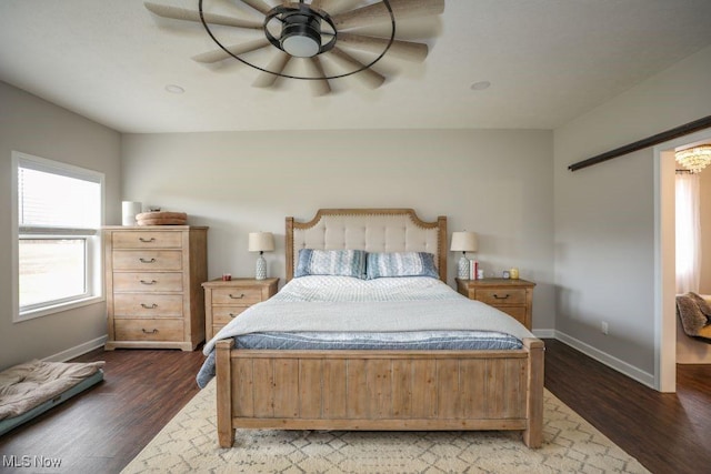 bedroom with baseboards, dark wood finished floors, and a ceiling fan