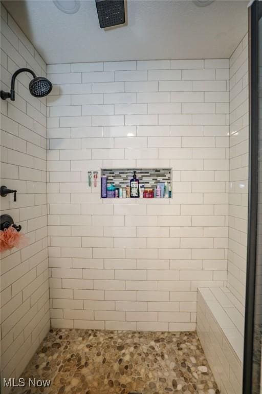 bathroom with a tile shower