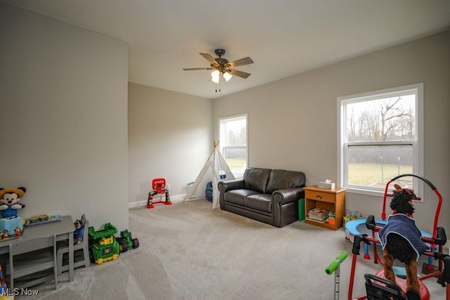 recreation room featuring baseboards, ceiling fan, and carpet flooring