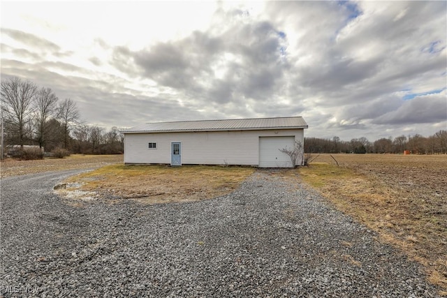 view of outbuilding with an outbuilding and gravel driveway