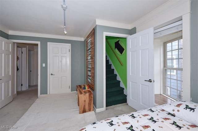 carpeted bedroom with baseboards and crown molding