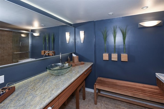 bathroom with a shower with door and vanity