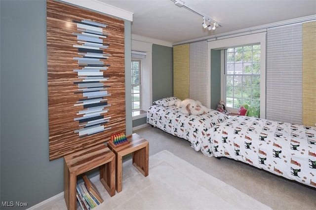 carpeted bedroom featuring baseboards