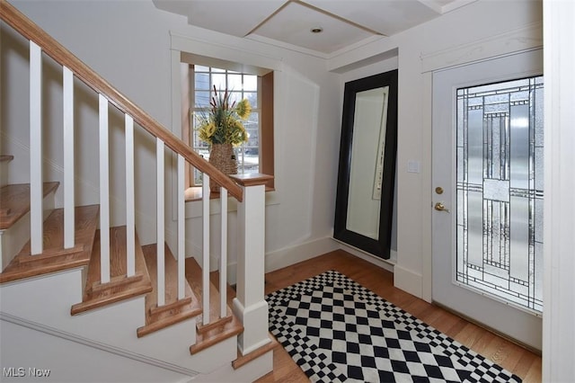 foyer with wood finished floors and stairs