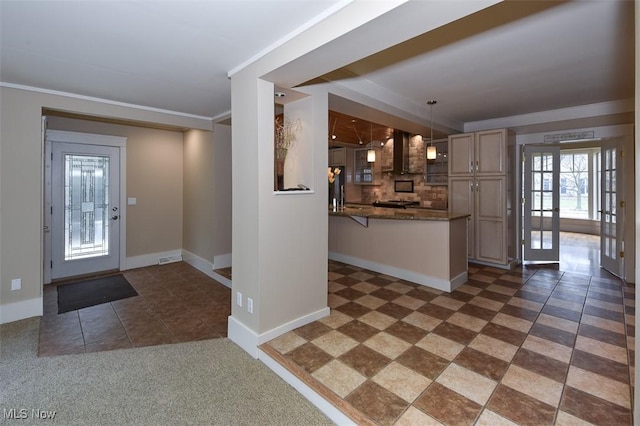 foyer entrance featuring french doors, crown molding, and baseboards