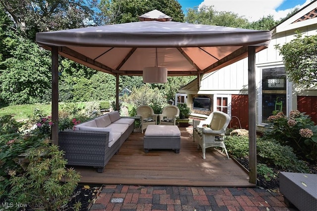 deck featuring a gazebo and an outdoor living space