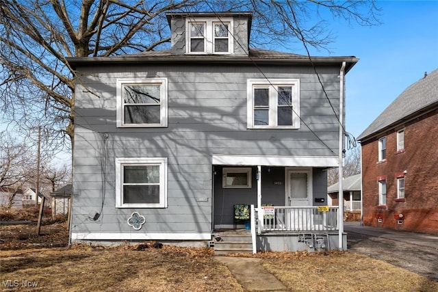 american foursquare style home with a porch