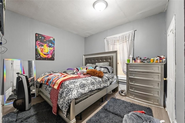 bedroom with wood finished floors