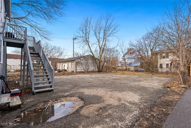 view of yard featuring stairway and an outdoor structure