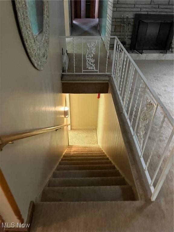 staircase featuring a fireplace