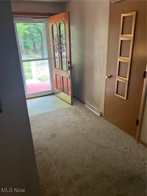 doorway to outside featuring carpet and visible vents