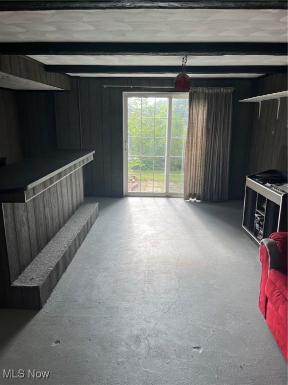 living room featuring beam ceiling