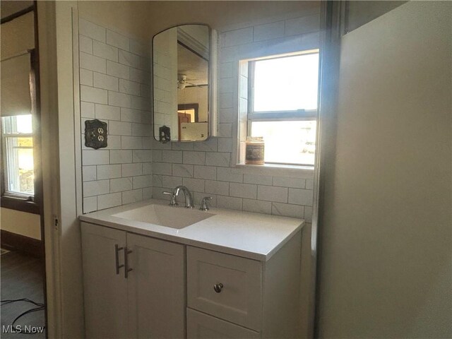 bathroom with vanity and decorative backsplash