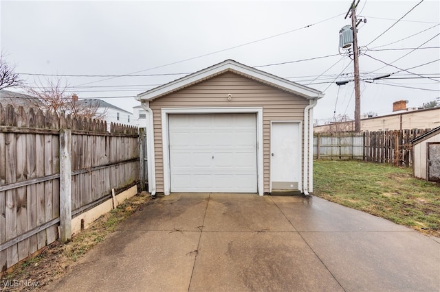 detached garage with driveway and fence