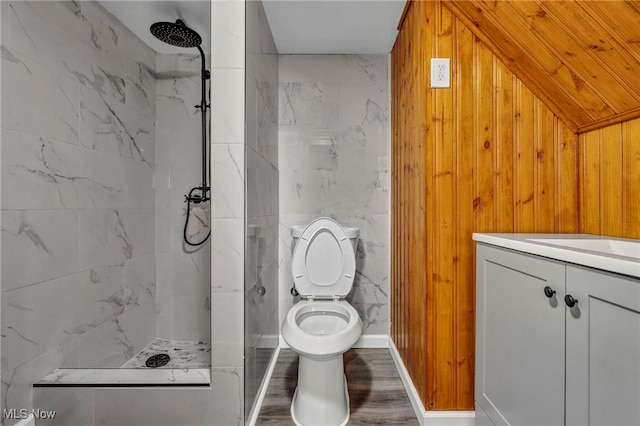 bathroom with toilet, vanity, a marble finish shower, and wood finished floors