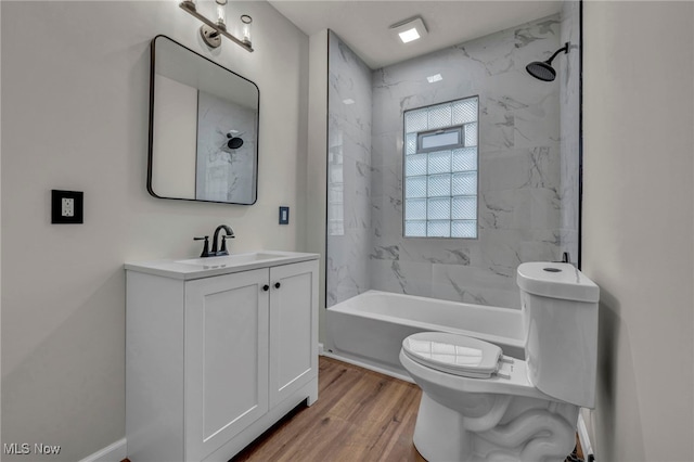 bathroom with vanity, shower / bathing tub combination, wood finished floors, and toilet