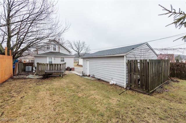 back of house with a yard, a fenced backyard, a wooden deck, and central air condition unit