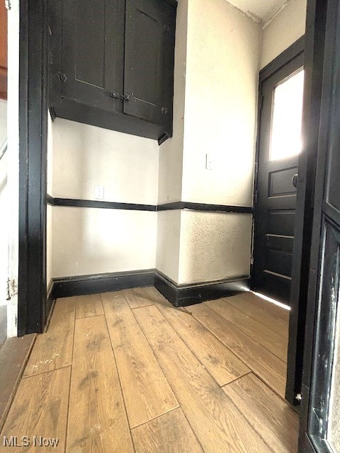 interior space with light wood-style floors and baseboards