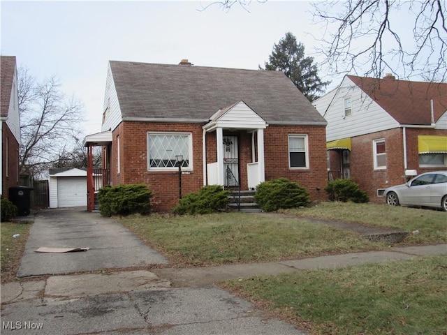 view of front of home featuring brick siding, roof with shingles, a garage, an outdoor structure, and a front lawn