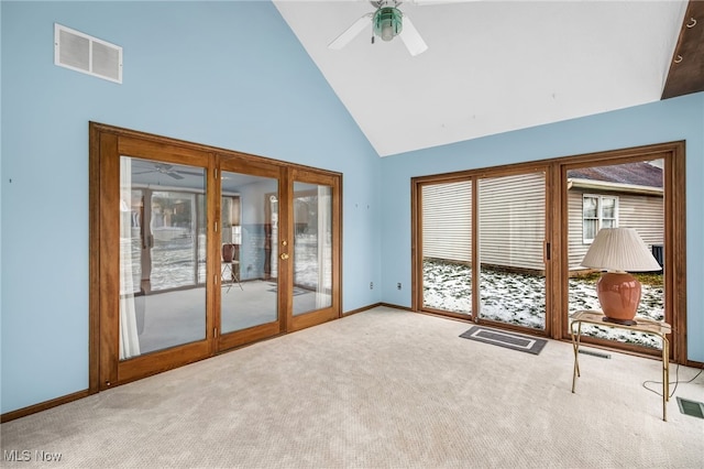 interior space with carpet floors, visible vents, high vaulted ceiling, and a ceiling fan